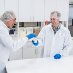Two people sampling baked inclusions in a laboratory