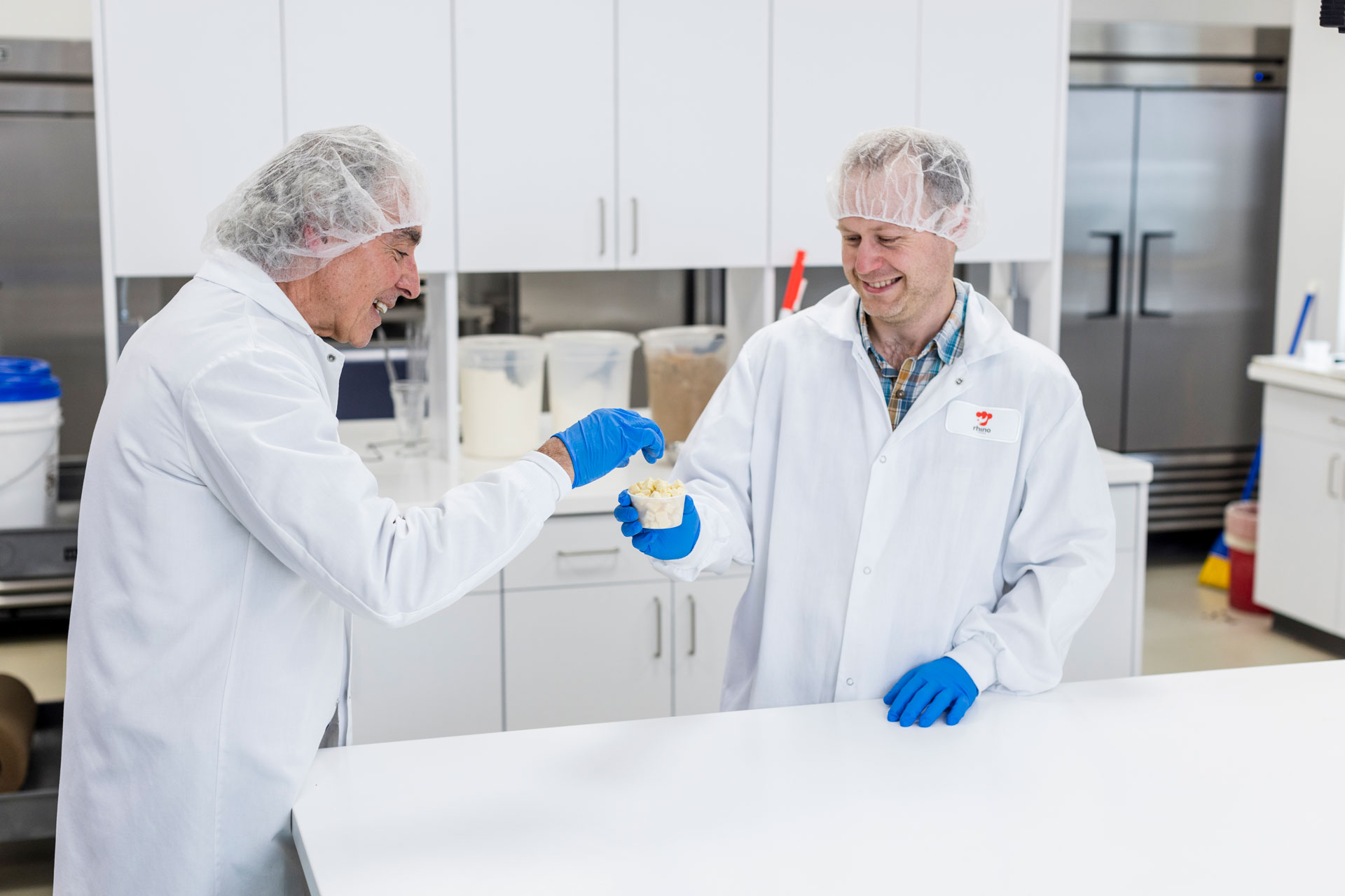 Two people sampling baked inclusions in a laboratory