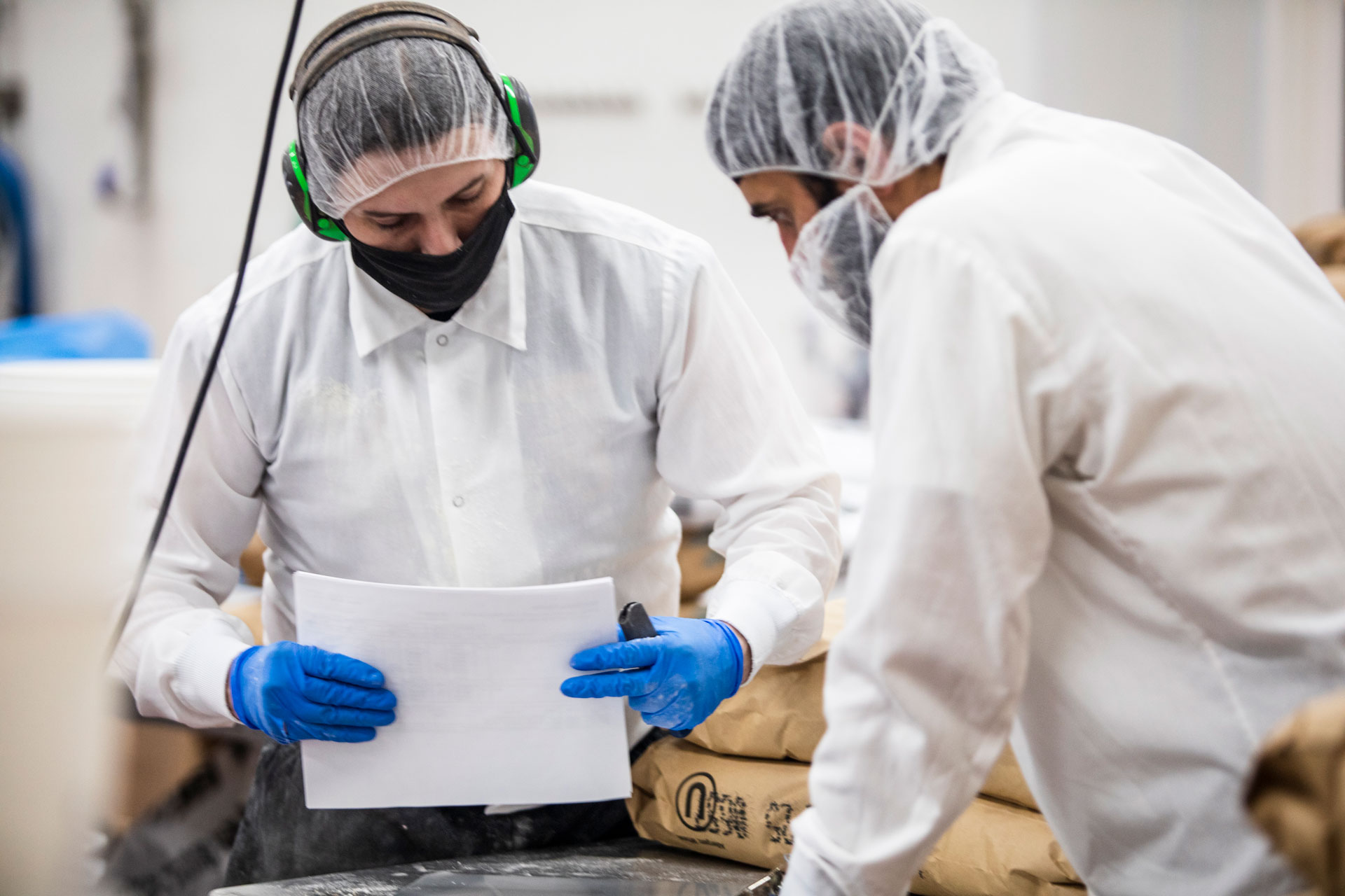 food manufacturing workers looking over paperwork