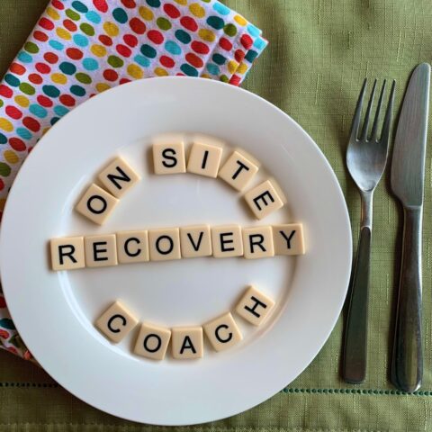 on-site recovery coach spelled out in scrabble letters on a plate